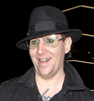 Marilyn Manson with shiny silver grillz on his teeth