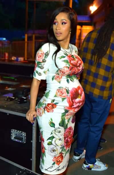 Cardi B in a vintage flower piece showing off her baby bump