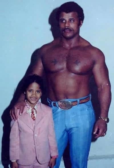 Young Dwayne Johnson with his muscular father who has strong genes