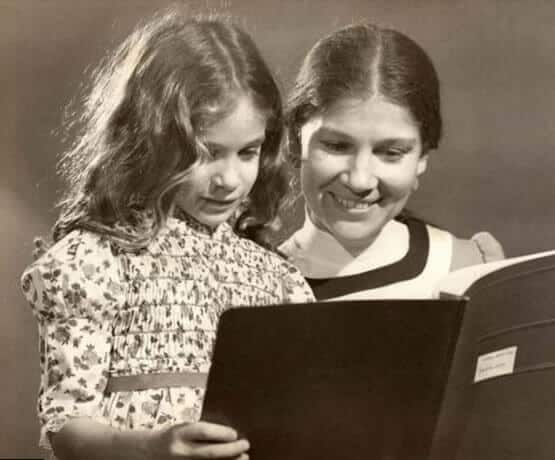 Young Sarah reading with her mom