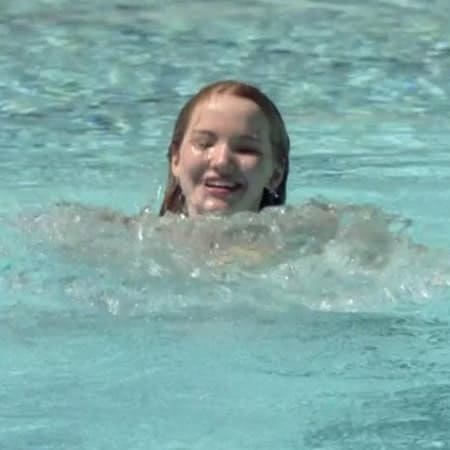 Dove Cameron swimming and splashing like a duck