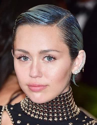 Miley Cyrus with short blue slicked back wet look hair in 2015