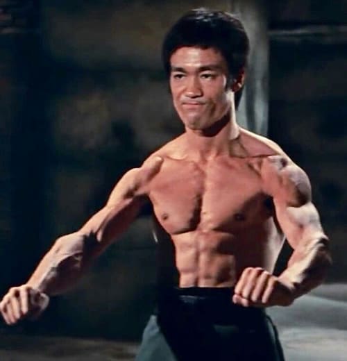 Bruce Lee flexing his muscular body