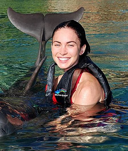 Megan Fox playing with dolphin