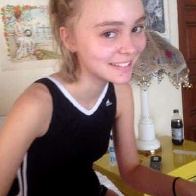 Lily-Rose Depp playing on her laptop