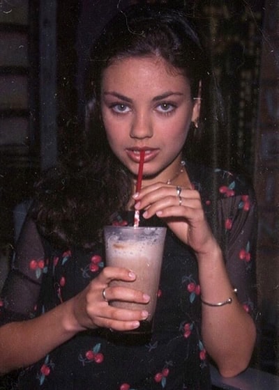 Mila Kunis having a sweet drink
